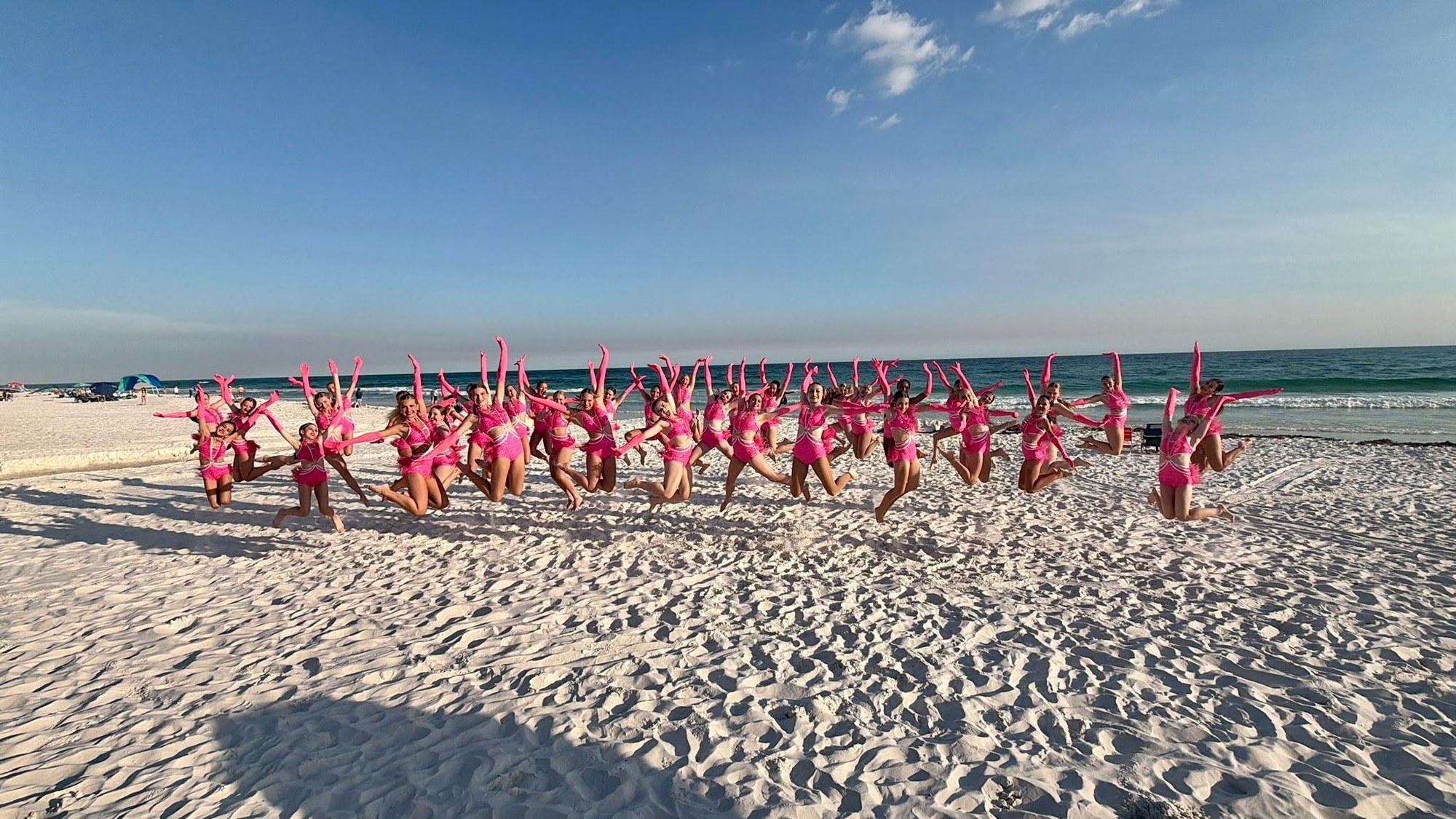 ExD dancers jumping on the beach
